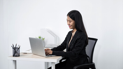 Young secretary woman using laptop to checking her boss's meeting and typing email to her boss
