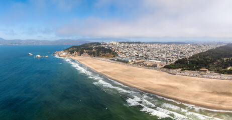 Where the sea meets the land in San Francisco. Ocean Beach is a world renowned surfing beach in the Sunset district of San Francisco. Cliff house building on the cliffs.