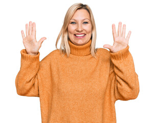 Middle age caucasian woman wearing casual winter sweater showing and pointing up with fingers number ten while smiling confident and happy.