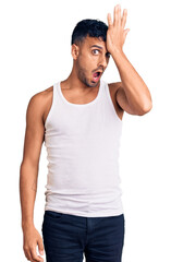Fototapeta premium Young hispanic man wearing casual clothes surprised with hand on head for mistake, remember error. forgot, bad memory concept.