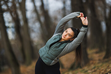 Woman Stretching Arms in Wooded Area