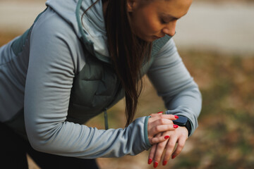 Woman Looking On Smart Watch Before Training Outdoor