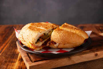 Mexican Torta. Sandwich made with common bread in Mexico, it can be telera, bolillo or bagette, split in half and filled with various ingredients, in this case spicy pork leg with Oaxaca cheese.