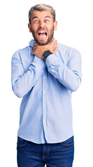 Young handsome blond man wearing elegant shirt shouting suffocate because painful strangle. health problem. asphyxiate and suicide concept.