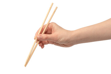 Female hand holding wooden sushi chopsticks isolated on white background.