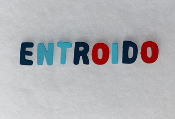 colored letters with the word Entroido in the language of Galicia on a white background and space...