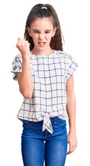 Cute hispanic child girl wearing casual clothes angry and mad raising fist frustrated and furious...