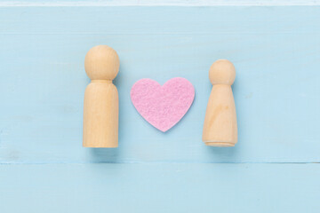 Wooden couple in love on wooden background, top view. Creative valentine's day composition