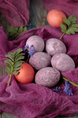 Still life of beautiful textured purple eggs on purple gauze