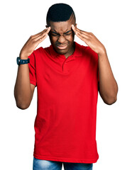Young african american man wearing casual red t shirt with hand on head, headache because stress. suffering migraine.