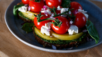 A Gourmet Vegetarian Feast Featuring Fresh Tomatoes and Avocado on a Rustic Table