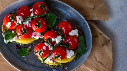A Gourmet Vegetarian Feast Featuring Fresh Tomatoes and Avocado on a Rustic Table