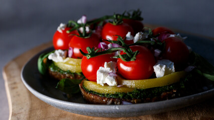 A Gourmet Vegetarian Feast Featuring Fresh Tomatoes and Avocado on a Rustic Table