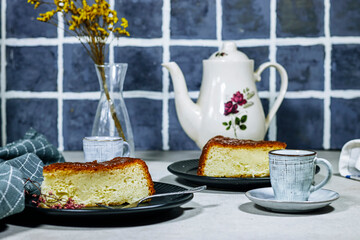 Homemade dessert rum baba with apricot jam decorated with gypsophila flower and coffee