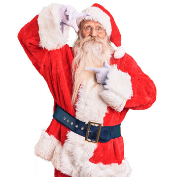 Old senior man with grey hair and long beard wearing traditional santa claus costume smiling making frame with hands and fingers with happy face. creativity and photography concept.