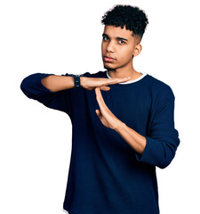 Young african american man wearing casual clothes doing time out gesture with hands, frustrated and...