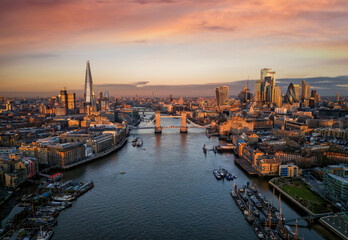 Panoramic view of the skyline of London during a sunrise with Tower Bridge and the skyscrapers of...