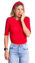 Beautiful caucasian woman wearing casual clothes and red diadem looking stressed and nervous with hands on mouth biting nails. anxiety problem.