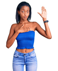 Young african american woman wearing casual summer clothes swearing with hand on chest and open palm, making a loyalty promise oath