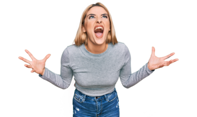 Young caucasian woman wearing casual clothes crazy and mad shouting and yelling with aggressive expression and arms raised. frustration concept.
