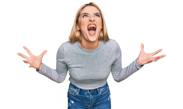 Young caucasian woman wearing casual clothes crazy and mad shouting and yelling with aggressive expression and arms raised. frustration concept.