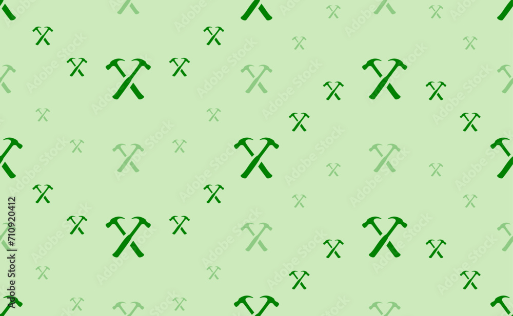 Poster Seamless pattern of large and small green crossed hammers symbols. The elements are arranged in a wavy. Vector illustration on light green background