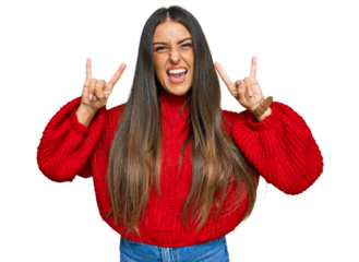 Beautiful hispanic woman wearing casual clothes shouting with crazy expression doing rock symbol with hands up. music star. heavy music concept.