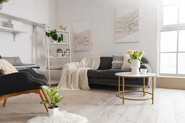 Interior of stylish living room with cozy sofa, armchair and synthesizer
