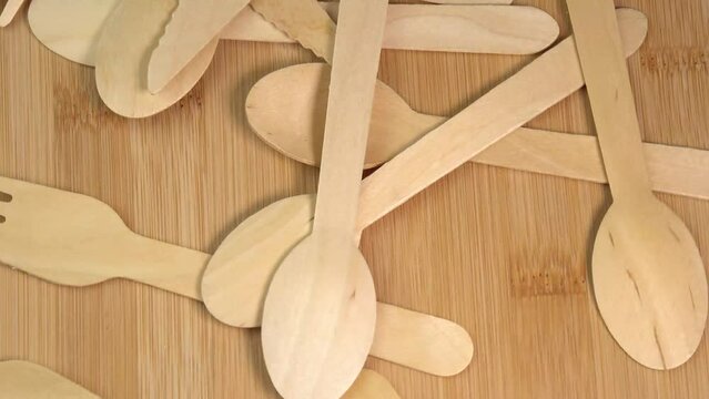 Wooden eco-friendly disposable tableware falling on