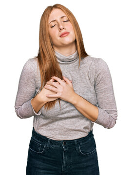 Young irish woman wearing casual clothes smiling with hands on chest with closed eyes and grateful gesture on face. health concept.