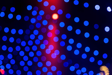 Glowing blue and red bokeh lights, festive mood in dark background