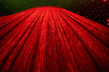 A curtain made of red plush fabric covering the stage.