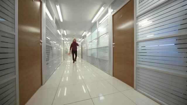 Man is walking on passageway in office of Donstroy company 