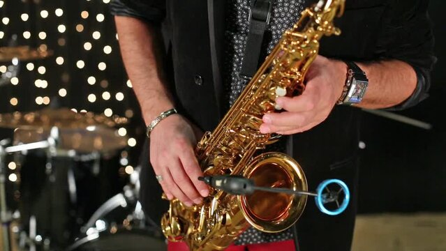 Close up view of the hands saxophonist playing a saxophone.