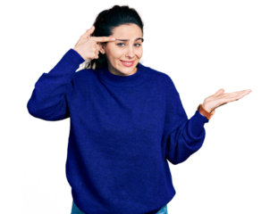 Young hispanic woman wearing casual clothes confused and annoyed with open palm showing copy space and pointing finger to forehead. think about it.