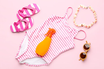 Composition with beach accessories on pink background