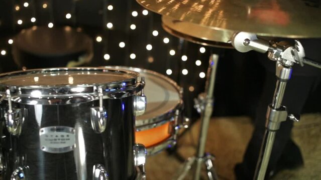 Close up view of the drum-set in studio with garlands.