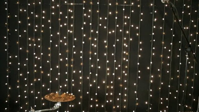 The drum-set is standing at scene in studio with garlands.