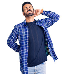 Young hispanic man wearing casual clothes suffering of neck ache injury, touching neck with hand,...