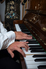 Close-up, hands playing the piano