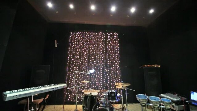 Studio room with musical instruments and record equipment.