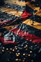 Raindrops on a black, red, and yellow surface