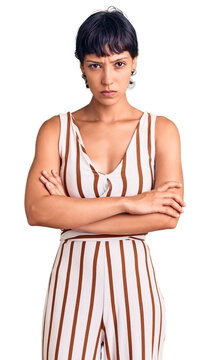 Young brunette woman with short hair wearing summer outfit skeptic and nervous, disapproving expression on face with crossed arms. negative person.