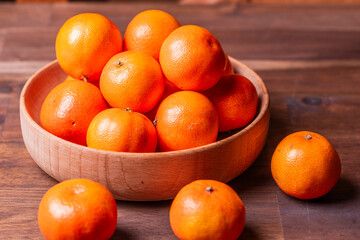 clementine mandarin fruit. mandarins in the wooden bowl.