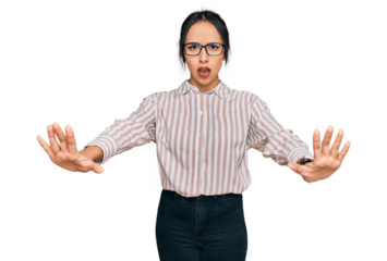 Young hispanic girl wearing casual clothes and glasses doing stop gesture with hands palms, angry and frustration expression