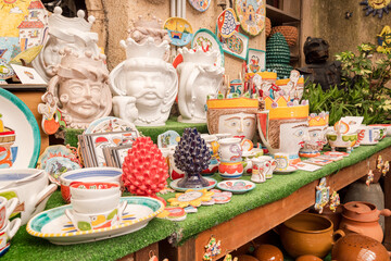 Traditional Sicilian handmade ceramic pottery products in typical souvenir shop in the historic center of Erici, province of Trapani, Western Sicily, Italy