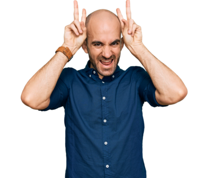 Young hispanic man wearing casual clothes posing funny and crazy with fingers on head as bunny ears, smiling cheerful