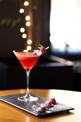 Captivating image of a deluxe cocktail, adorned with ice and burnt rosemary, set against a festive and romantically lit backdrop. Ideal for holiday-themed projects