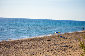 Fototapeta na wymiar Chalikounas Beach, Corfu Island. View of the deserted, sandy, windy beach on the western part of Corfu. Seascape. Travel and vacation concept.