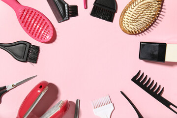 Frame made of hairdresser's tools on pink background